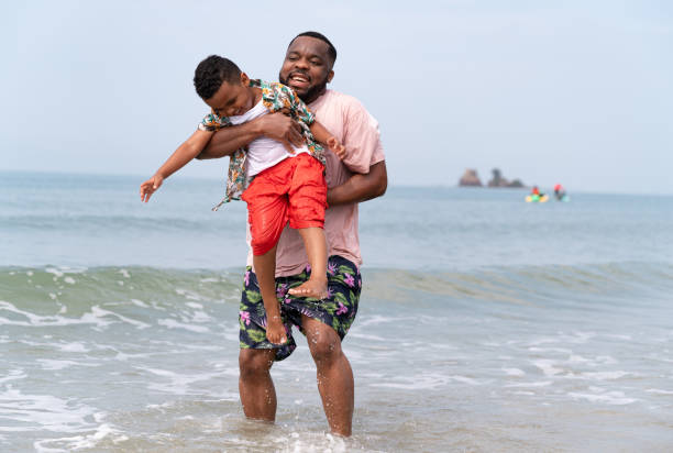 istock Happy father and son playing on the beach 1396224994
