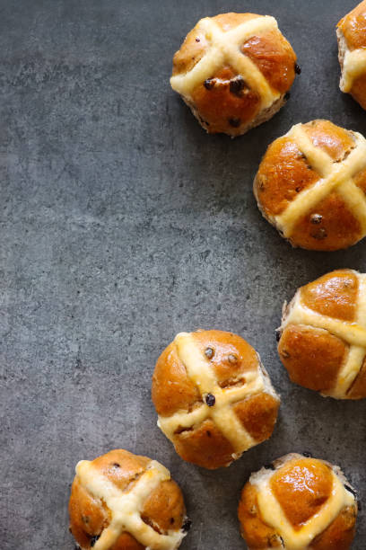 istock Image of freshly baked, homemade Easter hot cross buns on mottled grey background, elevated view, copy space 1396228401