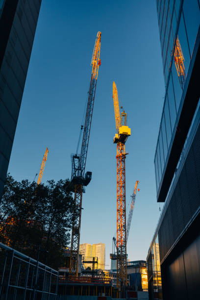 istock Cranes on construction site in financial district, by the office buildings 1396231180
