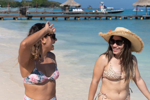 istock Hispanic Women enjoying summer vacations on beach. 1396234505