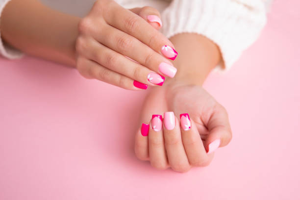 istock Female hands with pink manicure nails 1396234753