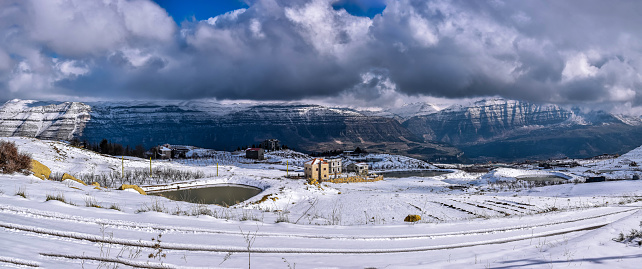 Panoramic view of snow on the mountains of a small Vilalge in Lebanon