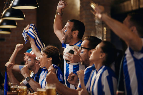 istock Cheering for favorite soccer team in a bar! 1396236047