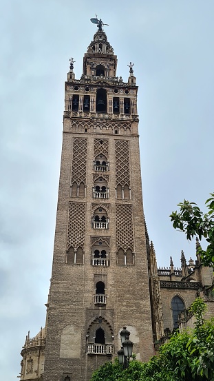 Sevilla, Spain – March 13, 2022:  La Giralda de Sevilla, the Muslim style bell tower of the Cathedral of Seville.