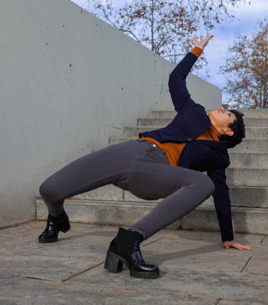 istock A woman dressed in semi-formal clothes who dancing extrangely on a middle of a steps 1396240621