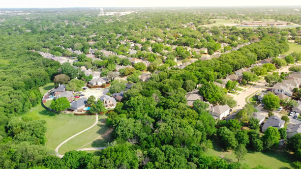 istock Top view upscale residential area with lush green trees, trail system, water tower in background at Flower Mound, Texas 1396243457