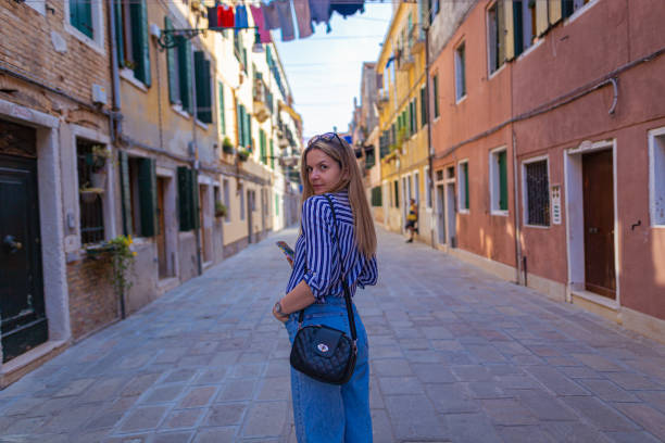 istock Tourist looking back in the street 1396244355
