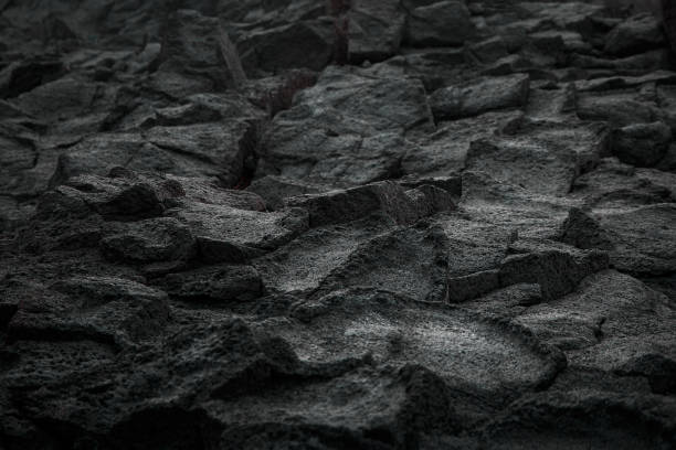 istock Volcanic rock black texture close up. 1396244478