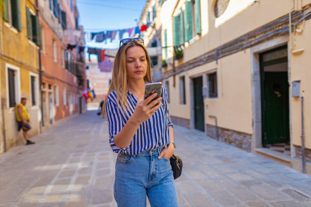 istock Female tourist using phone on the street 1396244511