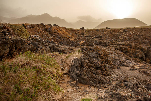 Volcanic landscape, sandstorm at sunset