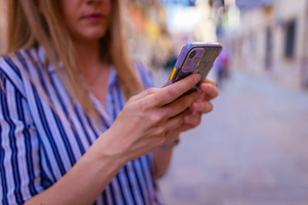 istock Female young tourist with smart phone in her hands 1396244631