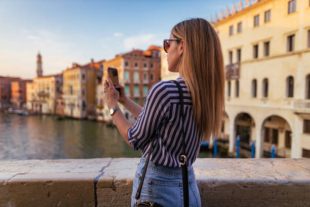 istock Young woman photographing view in Venice 1396244775