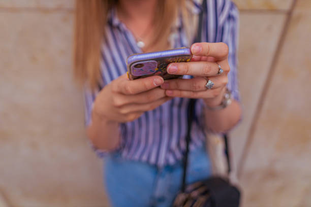 istock Female tourist typing on smart phone 1396244777