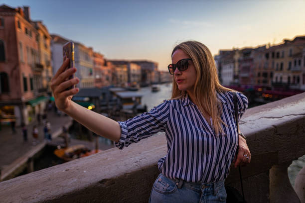 istock Confident young woman taking selfies 1396245380