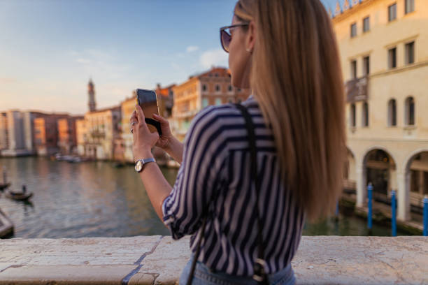 istock Young woman photographing Venice 1396245928