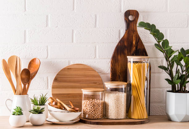 istock various kitchen utensils and containers for storing bulk products on a wooden countertop with a potted plant. stylish kitchen decor. close-up. 1396246984