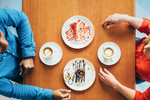 istock zenithal view of a couple before having a coffee and sweets snack 1396247560