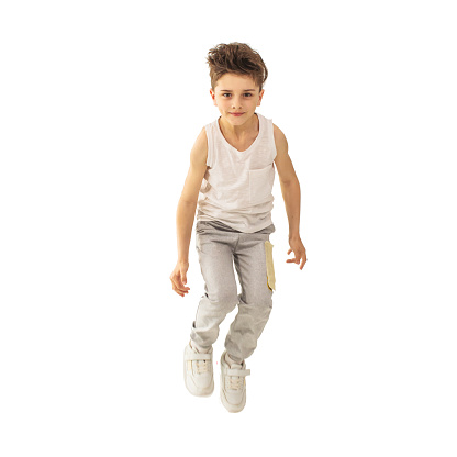 Cheerful boy jumping on white background isolated. Jump. Energy and vivacity. Happy child. Childhood