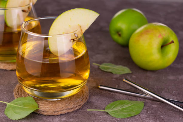istock Apple juice in a glass on a gray background.Close-up. 1396249310