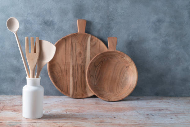 istock Modern kitchen kitchenware in light wood color with ladle, cutting boards and cookware on gray 1396250780