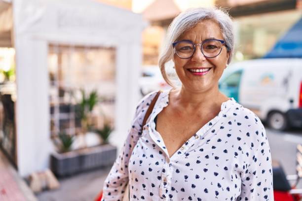 istock Middle age woman smiling confident standing at street 1396250948