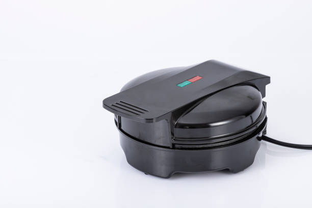 istock Kitchen Appliances - Closed Black Waffle Maker Isolated On Neutral Background 1396253682
