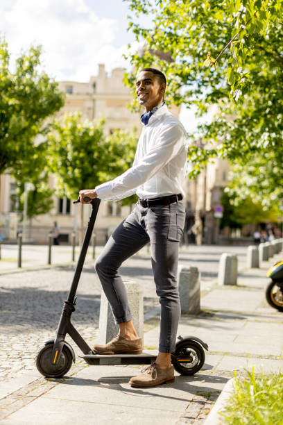 istock Young African American using electric scooter on a street 1396254002