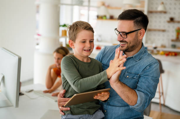 istock Distance learning, online education, home work concept. Family with digital devices at home. 1396256459