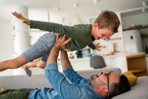 istock Joyful father and son having fun, spending tim at home together. Single dad concept 1396256538