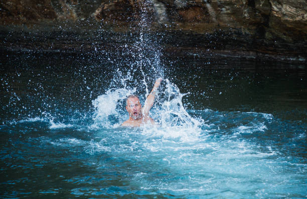 Woman throwing water in the sea with her hair.