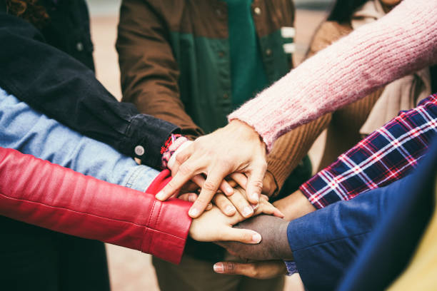 istock Young group of people stacking hands outdoor - Focus on hands 1396259102