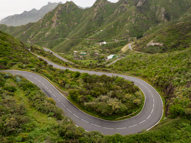 istock The winding road through the green mountain park. 1396260343