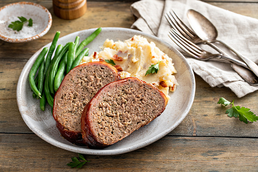 Meatloaf with mashed potatoes and green beans, traditional dinner meal, serving on a plate
