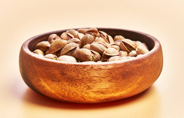 istock Bowl of pistachios over yellow background 1396261211