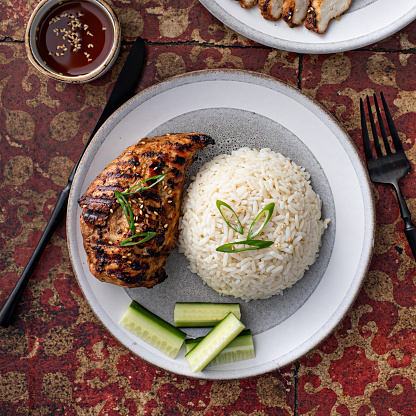 Grilled teriyaki honey ginger chicken breast with rice and fresh cucumber