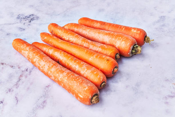 istock Bunch of carrots at marble surface 1396262183