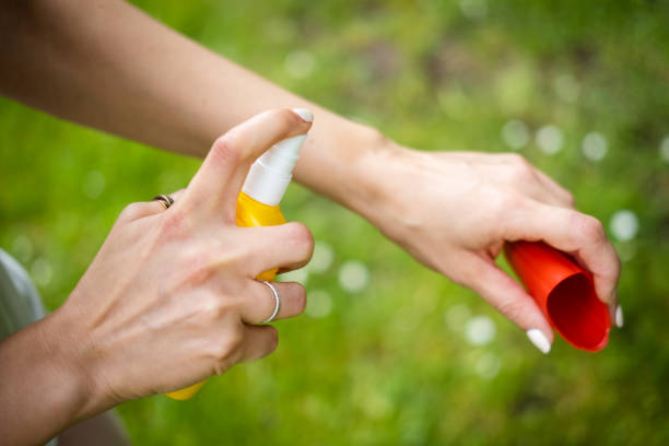 istock Close up on female hands applying insect repellent. 1396263605