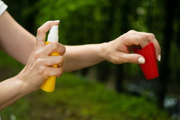 istock Close up on female hands applying insect repellent. 1396263619