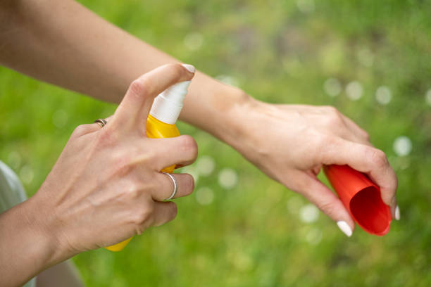 istock Close up on female hands applying insect repellent. 1396263636