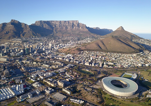 Cape Town, South Africa - 19 April 2022: Aerial view over Cape Town, with Cape Town stadium and Table Mountain .