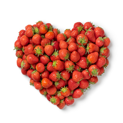 Fresh red ripe strawberries in heart shape isolated on white background