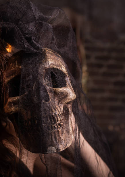 istock Halloween. Human skull in girl's hands. Under a black veil 1396265702