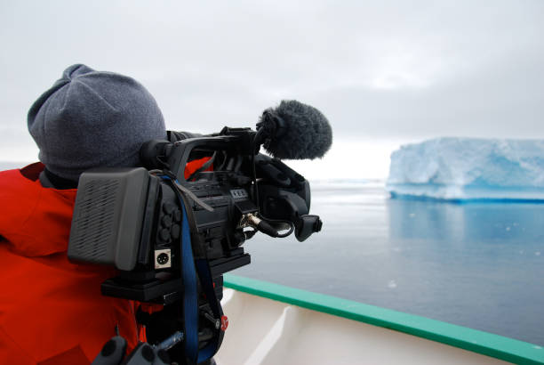 Cameraman filming an iceberg in Antarctica
