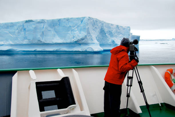 istock Cameraman filming an iceberg in Antarctica 1396269023
