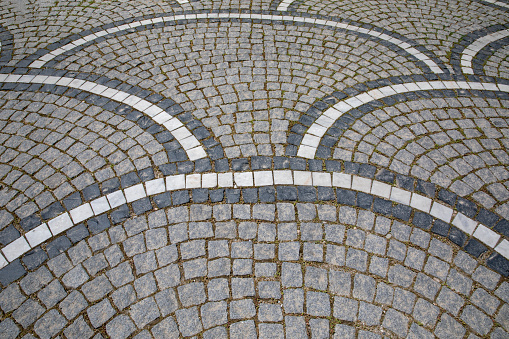 Abstract background. Old cobblestone pavement close-up.