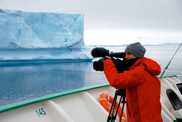 istock Cameraman filming an iceberg in Antarctica 1396269035