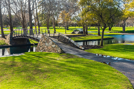 Historic Rymill Park bridge over the pond in Adelaide city on a sunny winter morning, South Australia