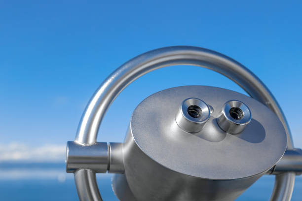 Coin Operated Binocular viewer or touristic telescope, trees and sea, panoramic view. Closeup.