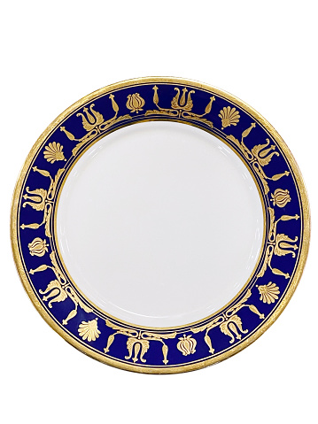 Porcelain white cup on a saucer with gilding. Isolated on a white background