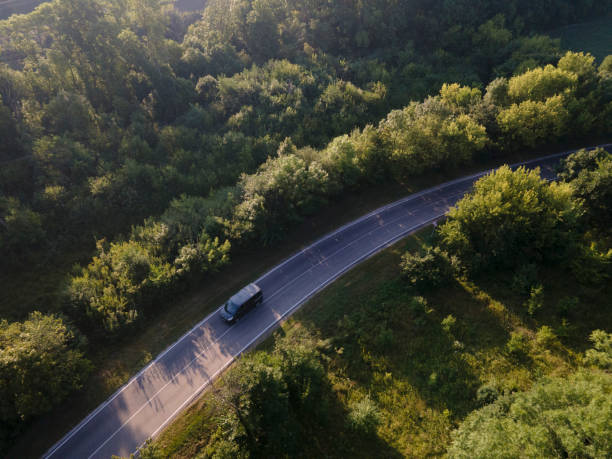istock Aerial view on Highway road in the forest. View from a drone. Ca 1396271833